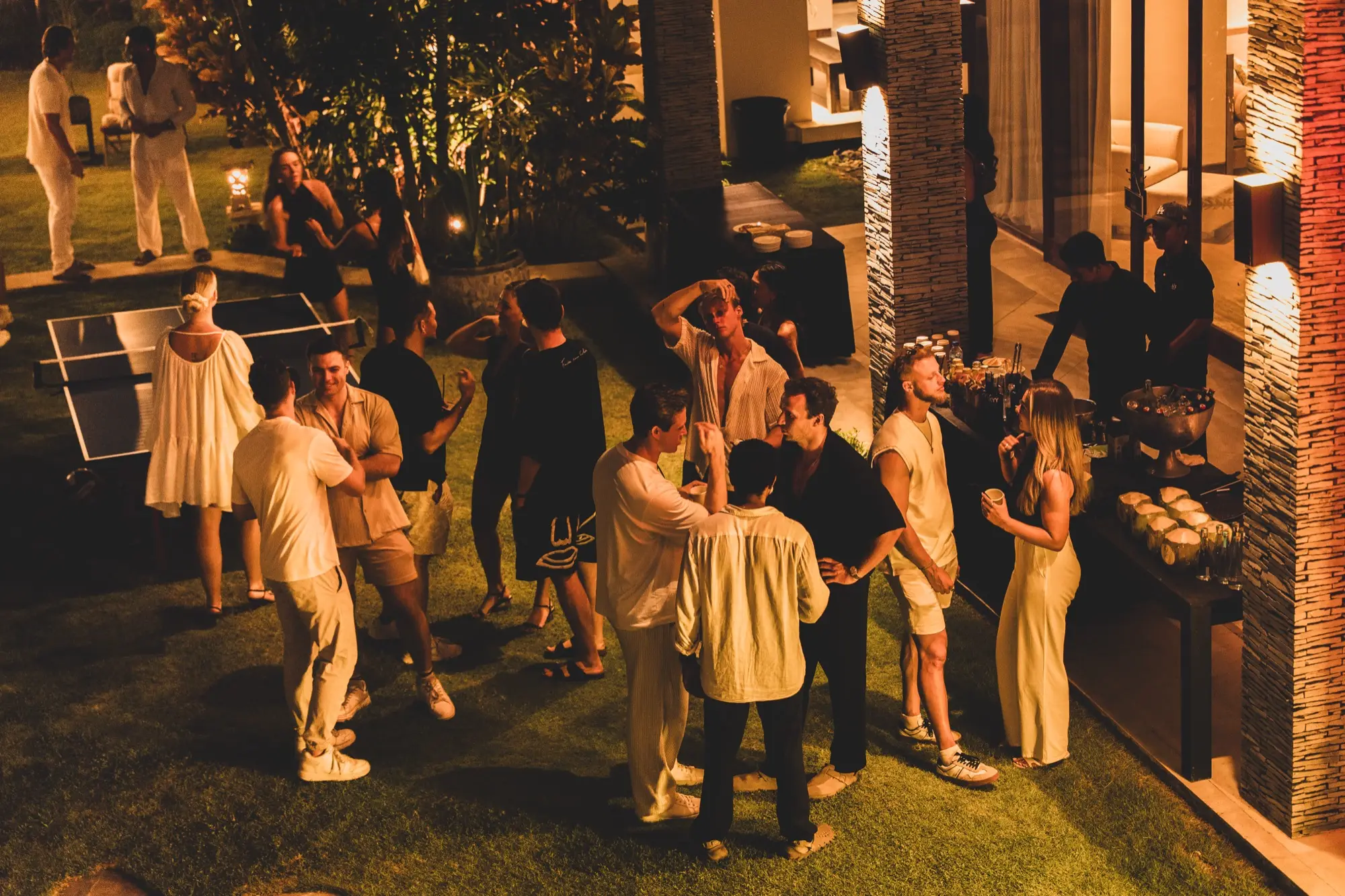 The garden full of guests at Edition 01, talking and laughing under the trees