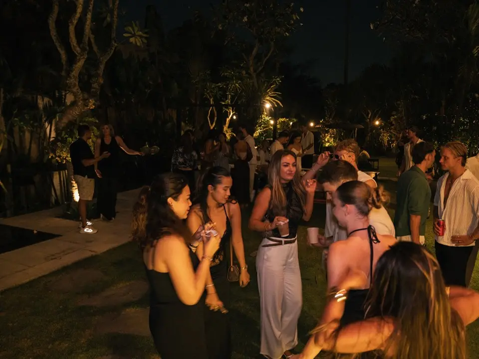 Guests dancing on the lawn at Edition 01, under string lights