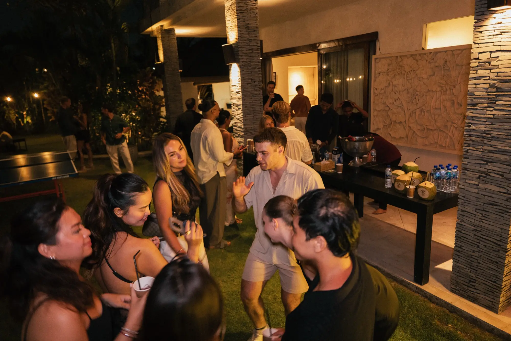 Guests on the terrace and the lawn in front of the villa